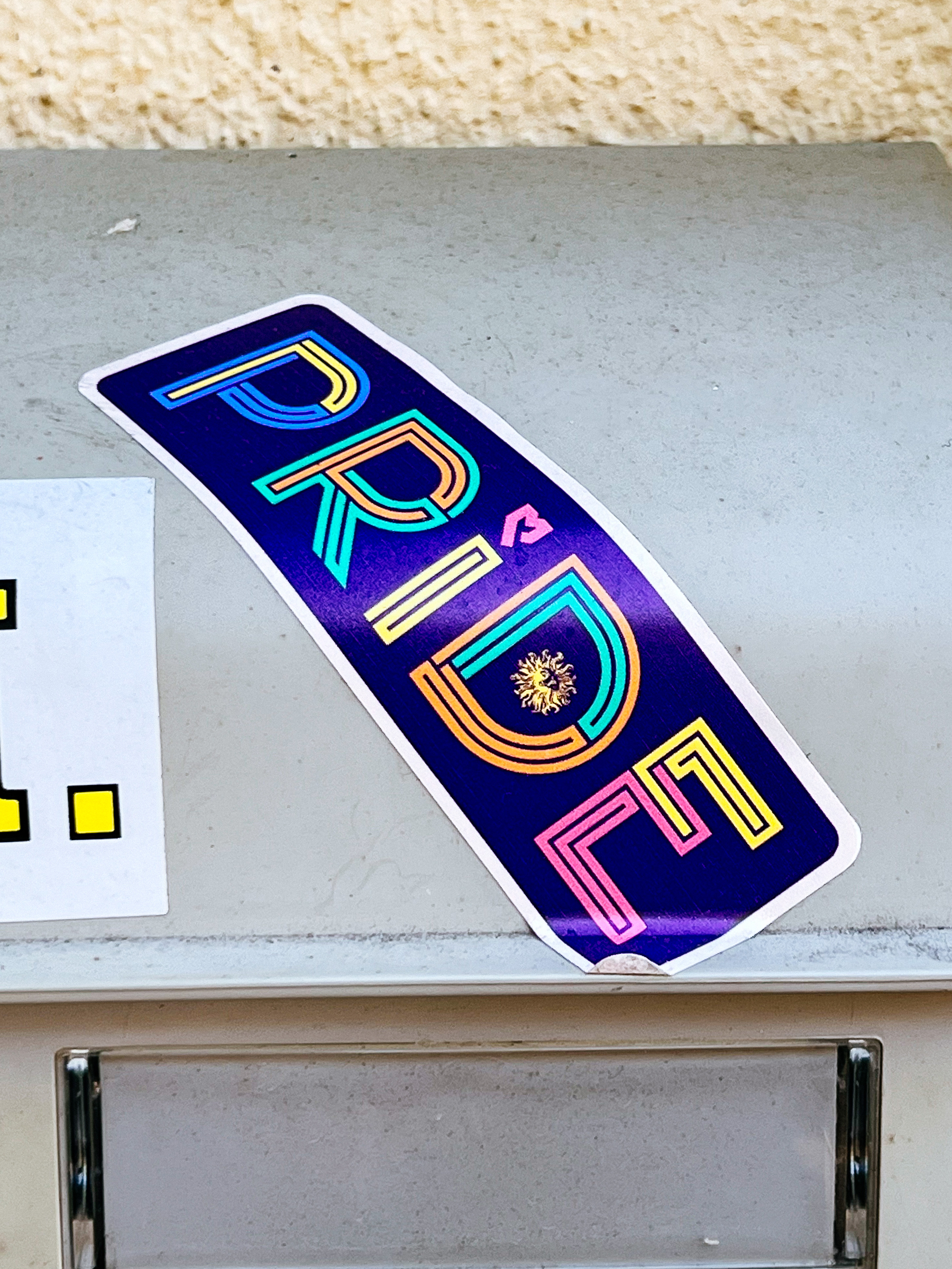 A sticker with the word “PRIDE”