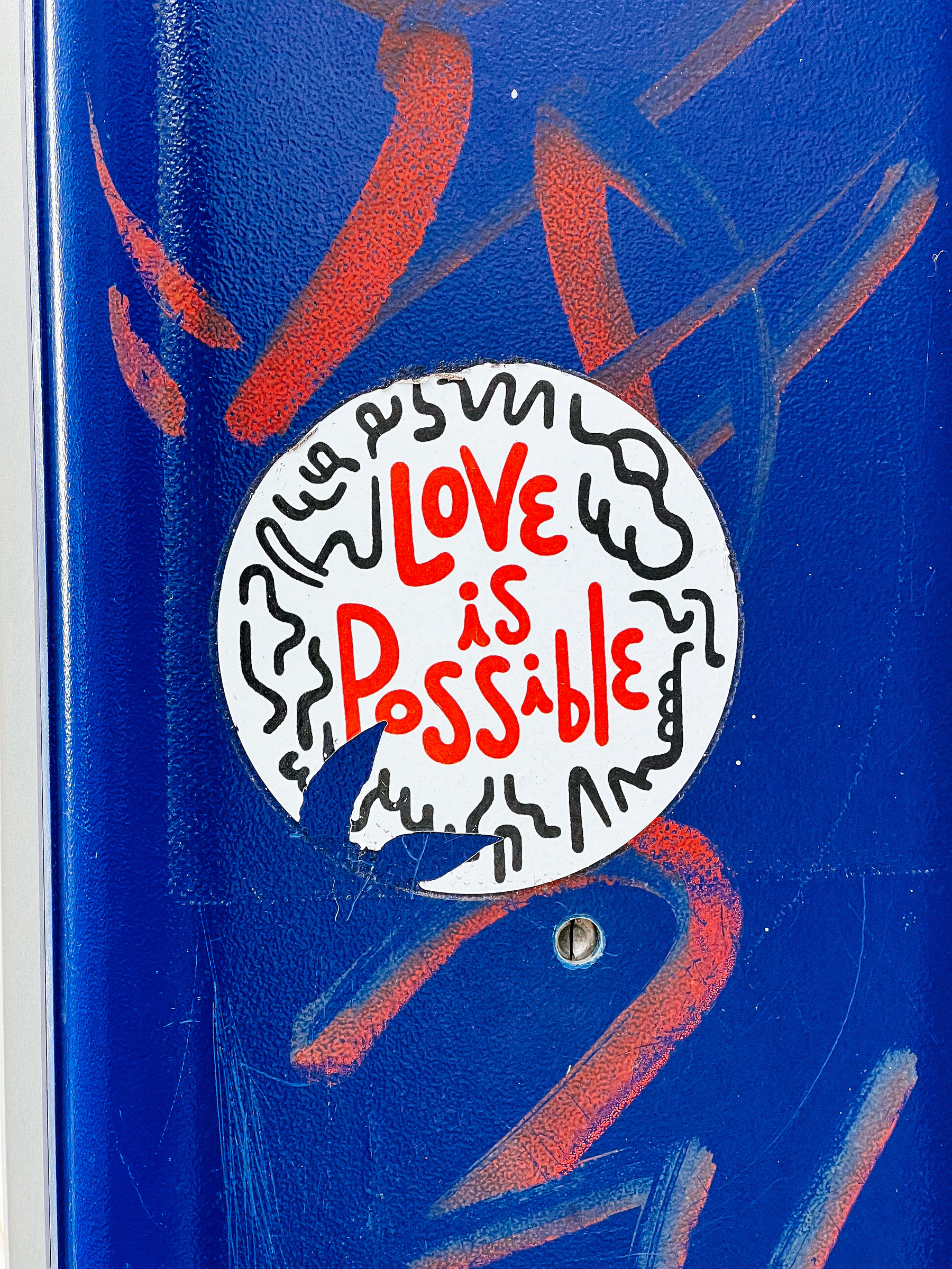 A sticker with the words “love is possible”