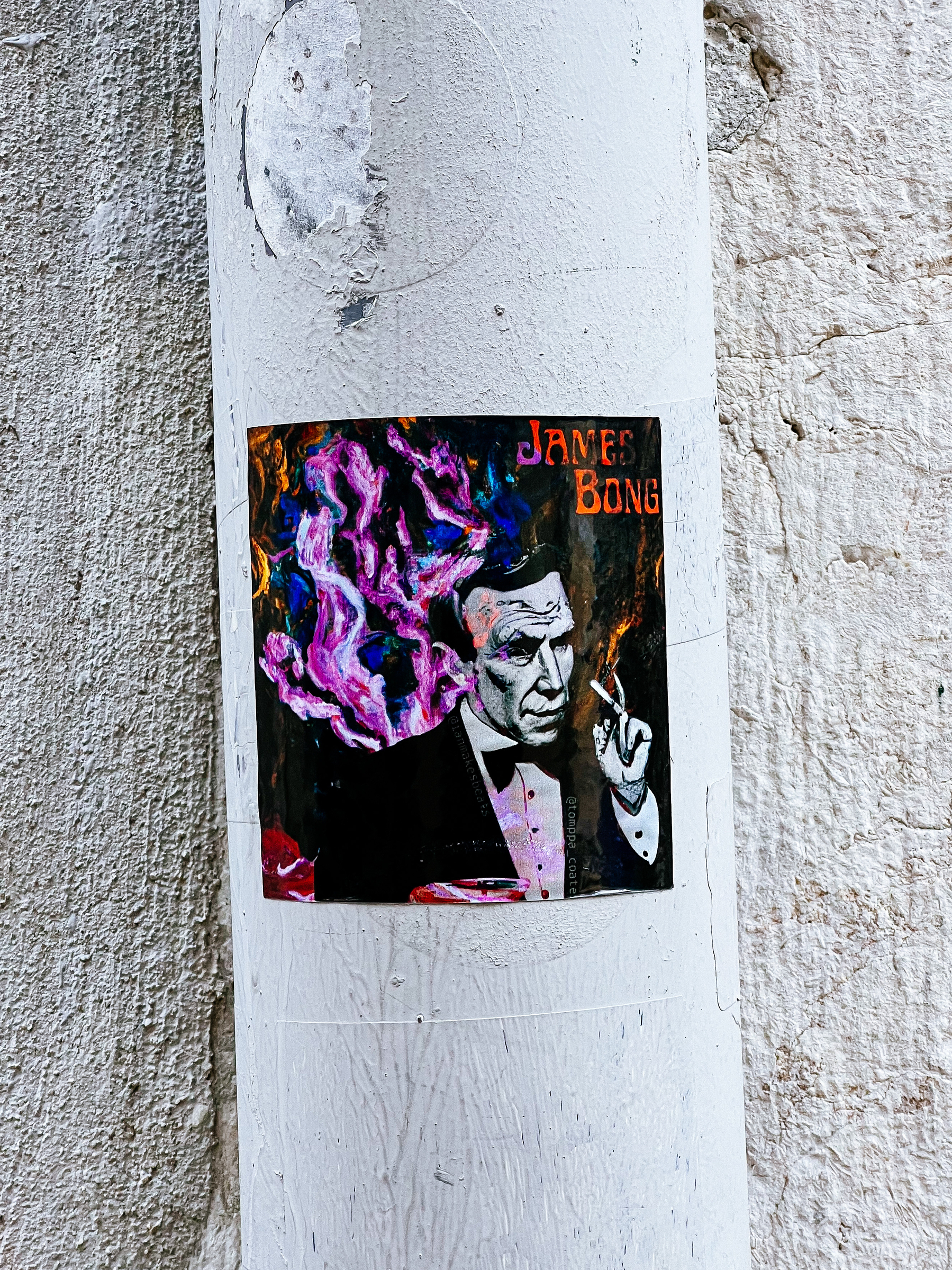 Sticker with a man dressed in a tuxedo, with a colorful cloud behind him, and the words “James Bong”. 