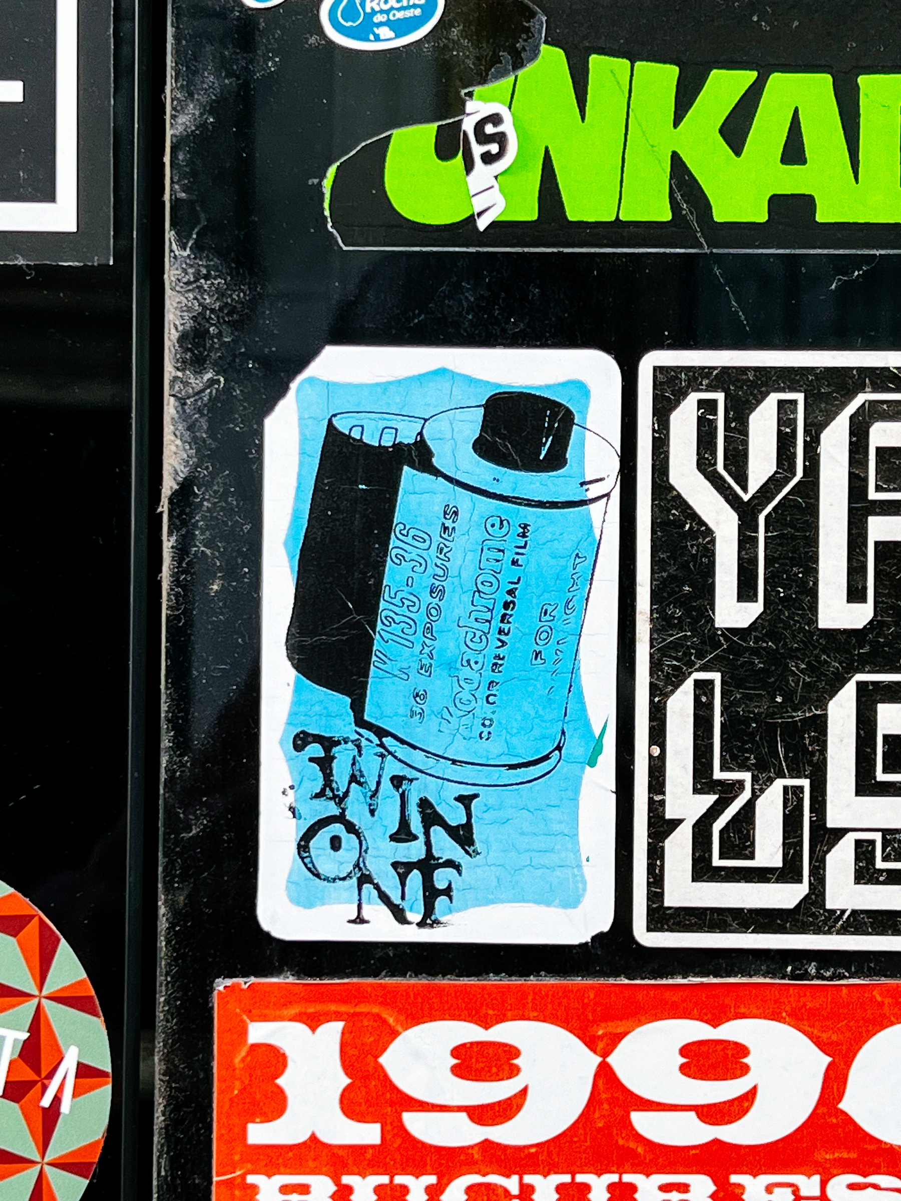 Sticker with a drawing of a Kodachrome film canister. 