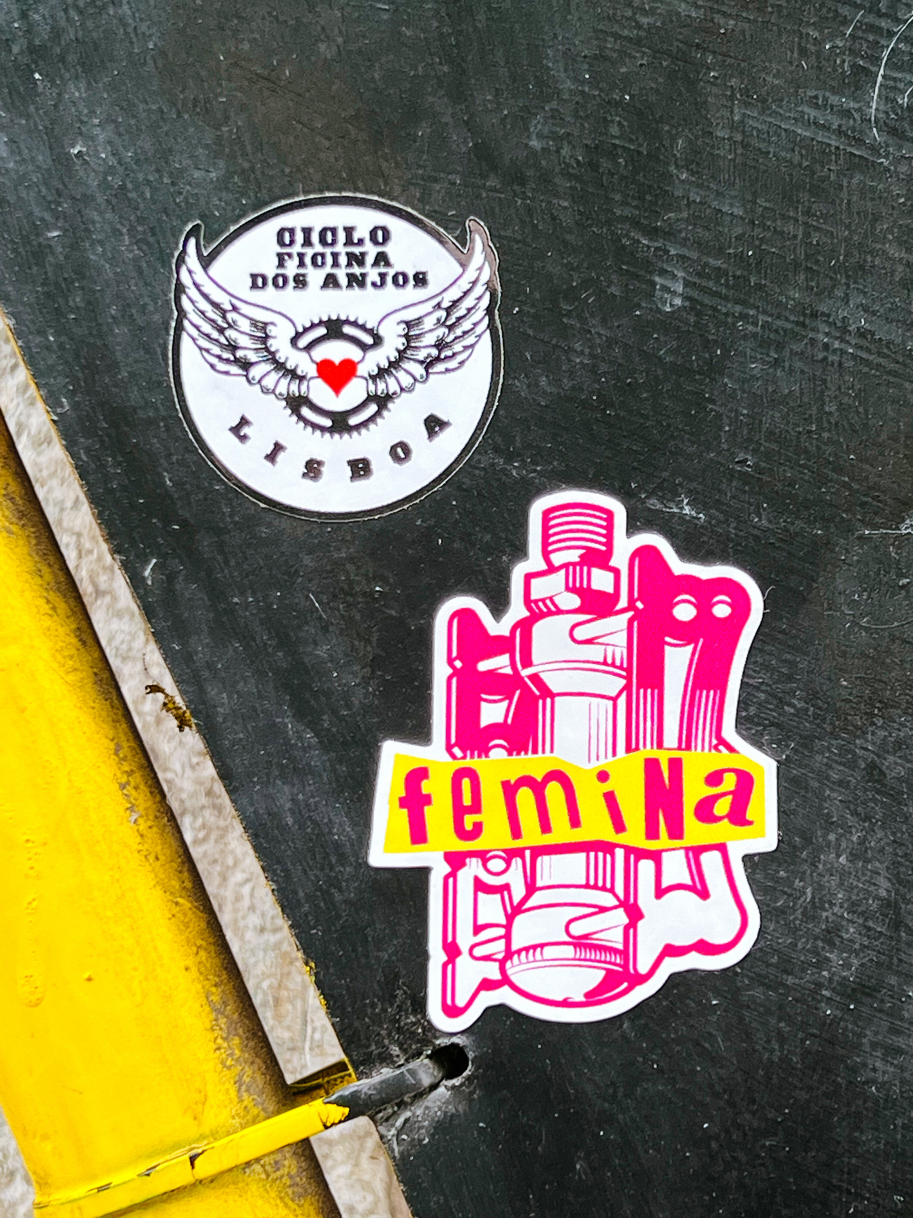 Two stickers for bicycle repair spots/community schools. “Cicloficina dos Anjos”, and “Femina”. 