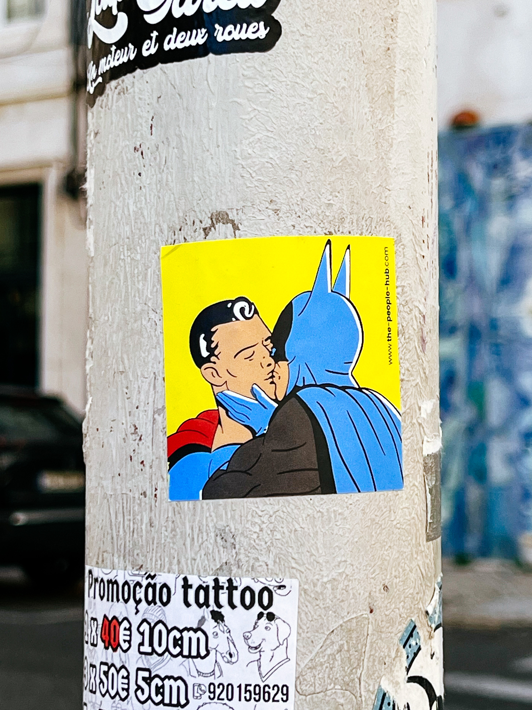 Sticker with Batman kissing Superman. 