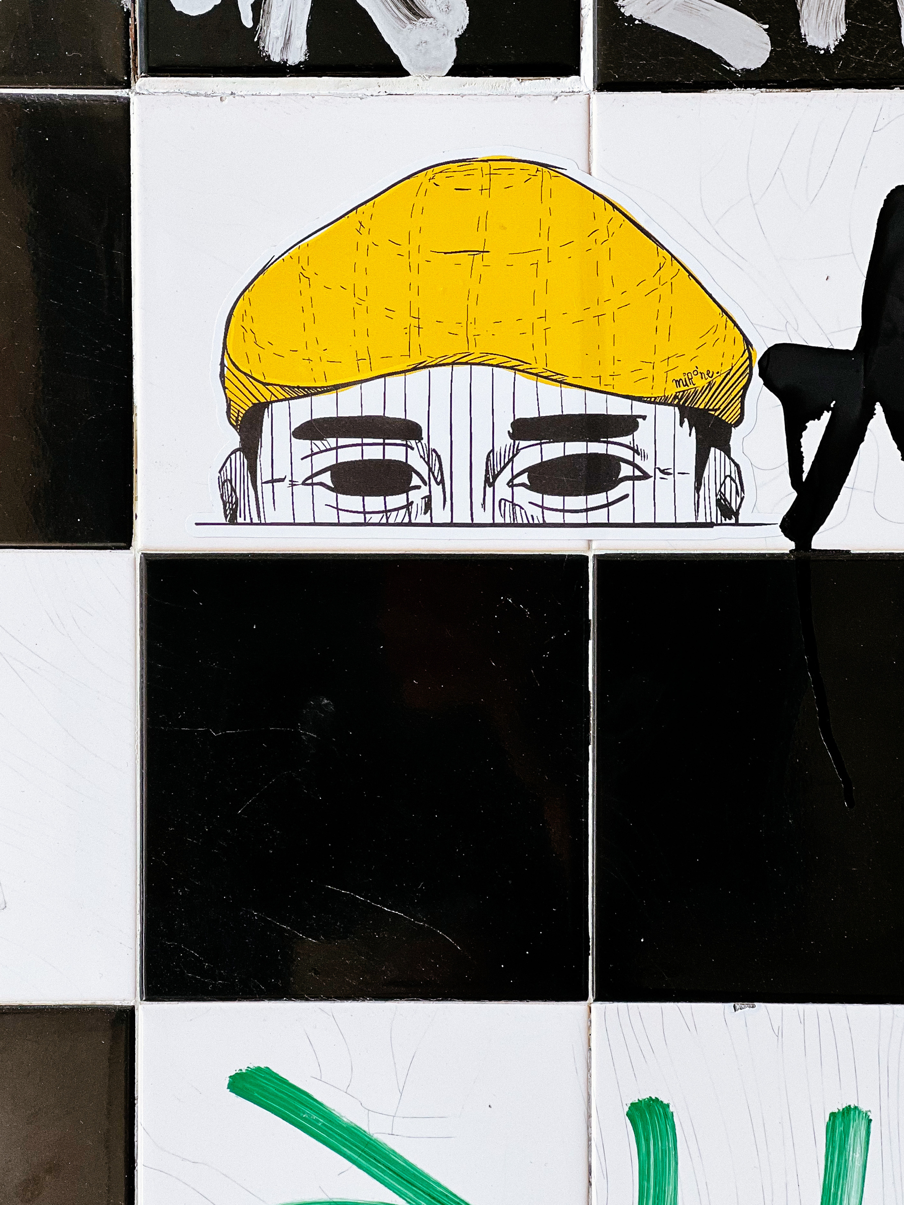 Sticker with the top of a man’s head, his eyes are showing, and he’s wearing a yellow cap. 
