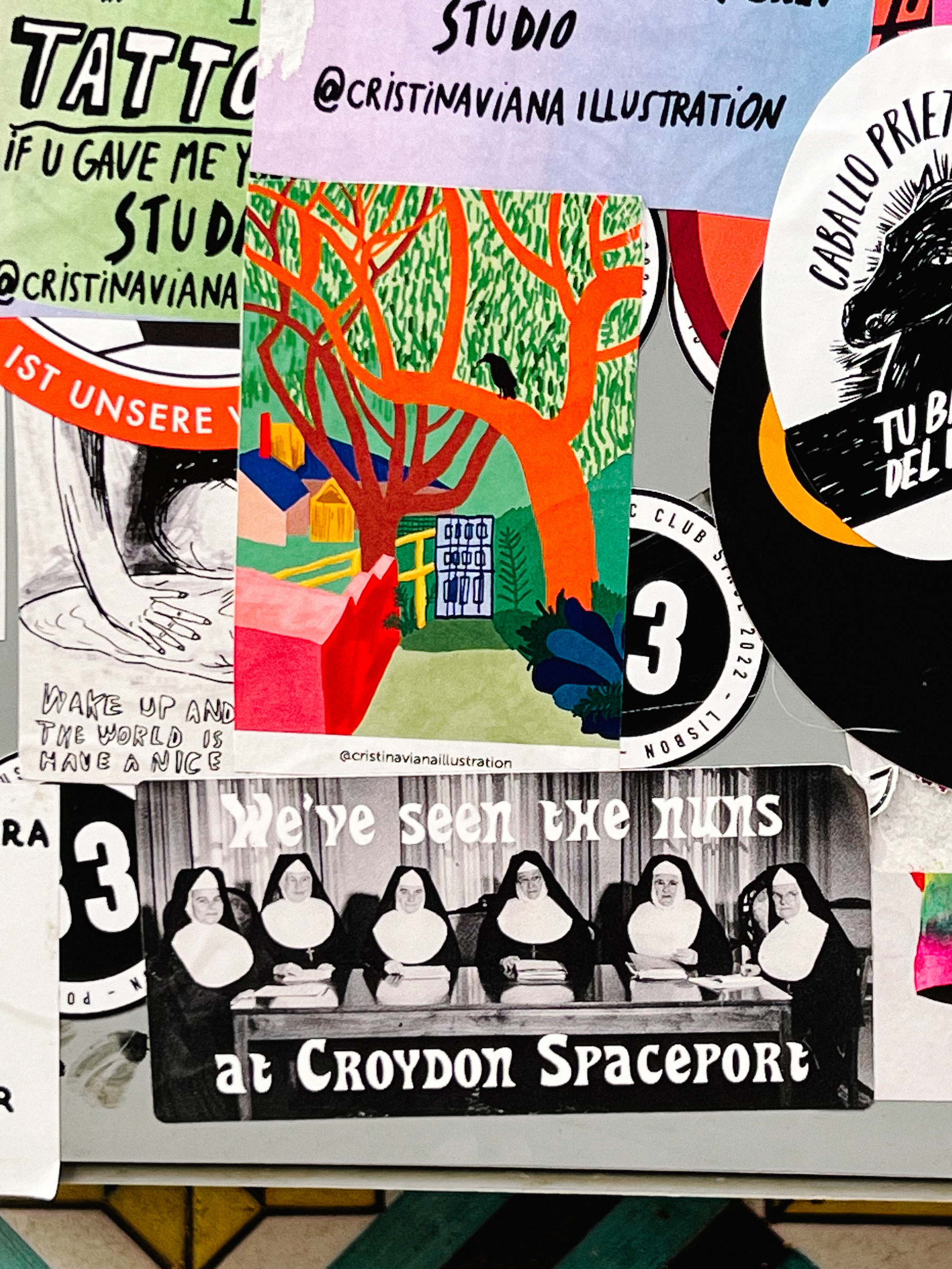 Several stickers, including one with a black and white photo of nuns sitting down at a table, and the words “We&rsquo;ve seen the nuns at Croydon Spaceport&quot;. 