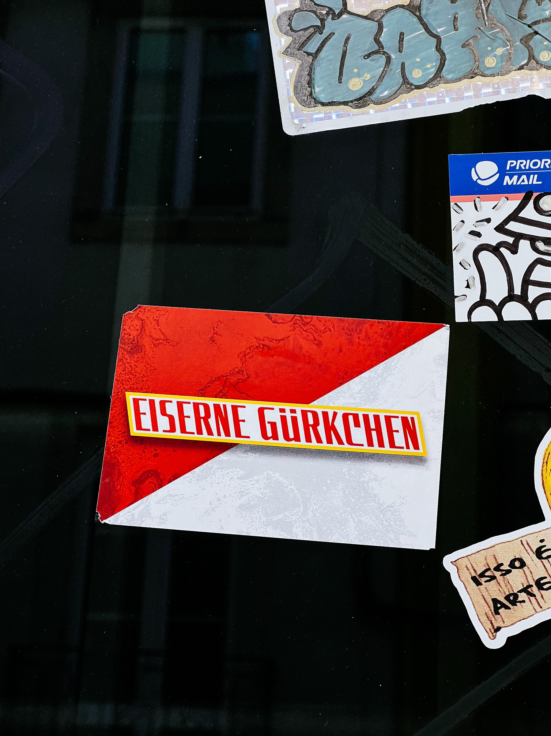 Sticker with what looks like a scuba flag (red and white), and the words “EISERNE GÜRKCHEN” written on top. 