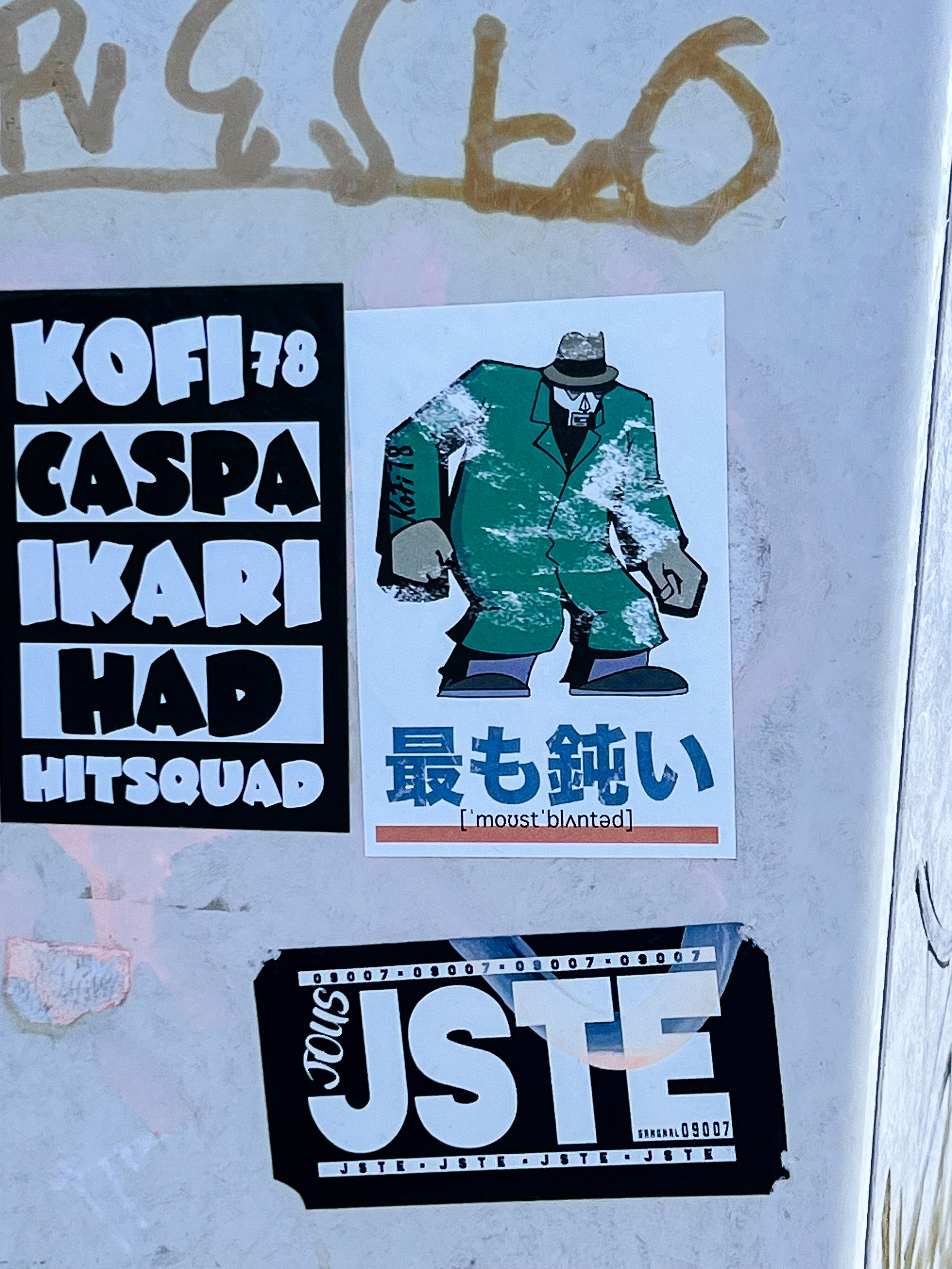 A sticker with a drawing of a big thug, and some Japanese characters under that. 