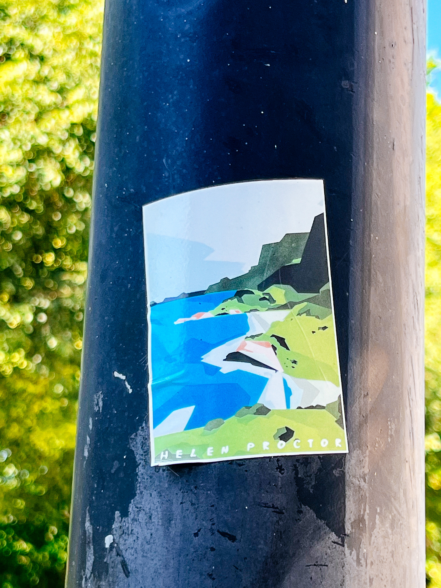 Seaside landscape, with “Helen Proctor” written at the bottom. Sticker. 