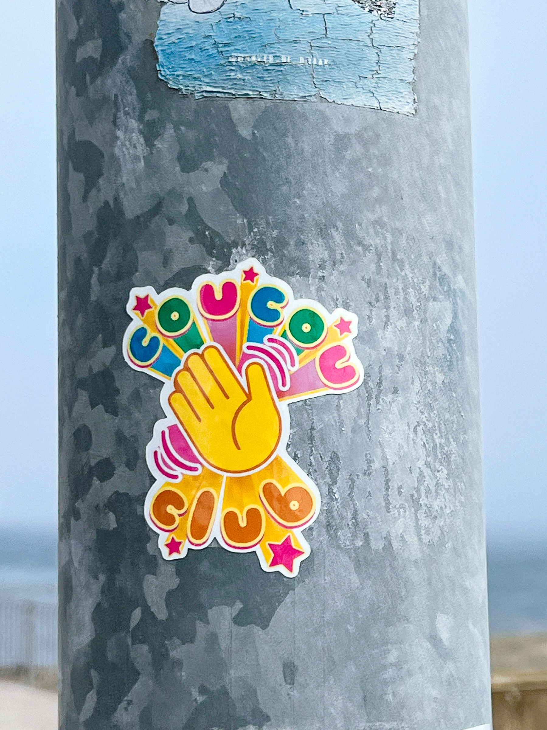 “Cou Cou Club”, and a waving hand emoji, on a sticker. 