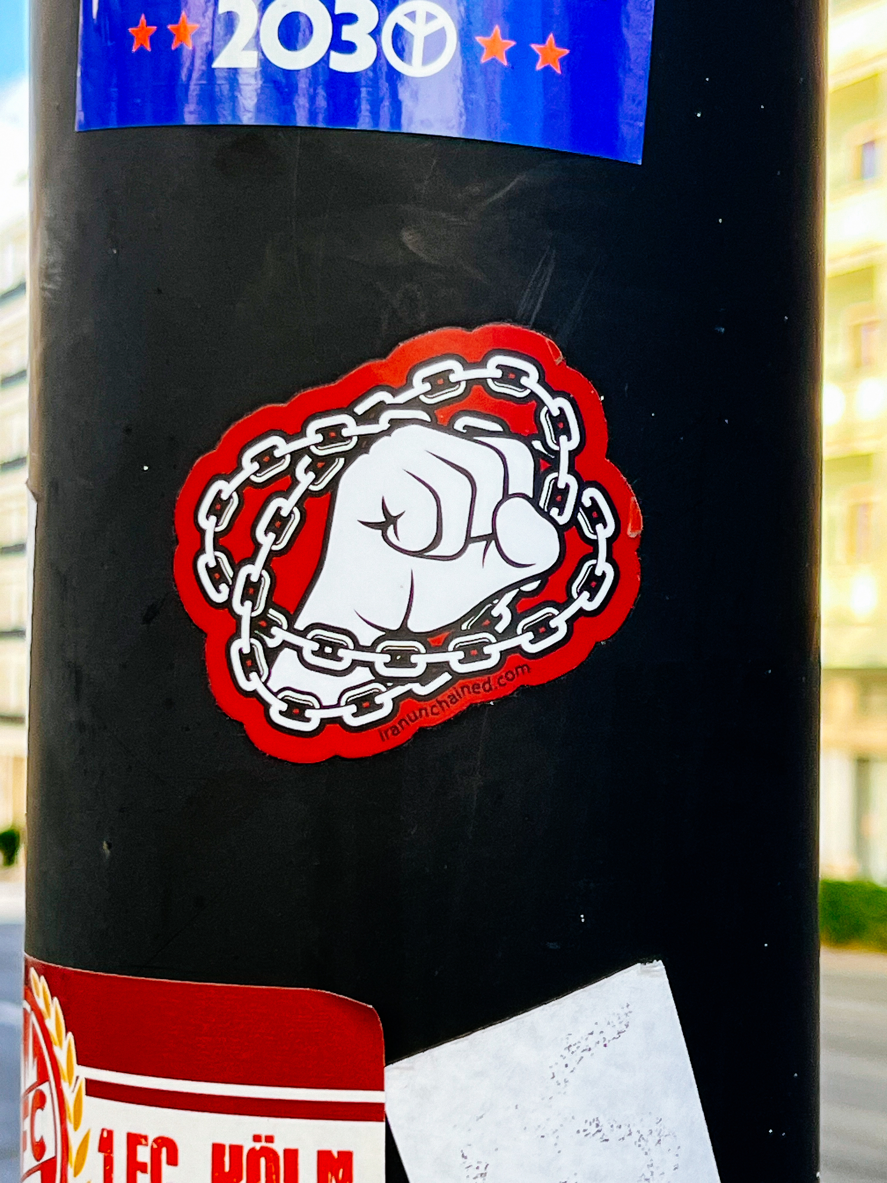 A sticker. A hand making a fist, surrounded by chains.
